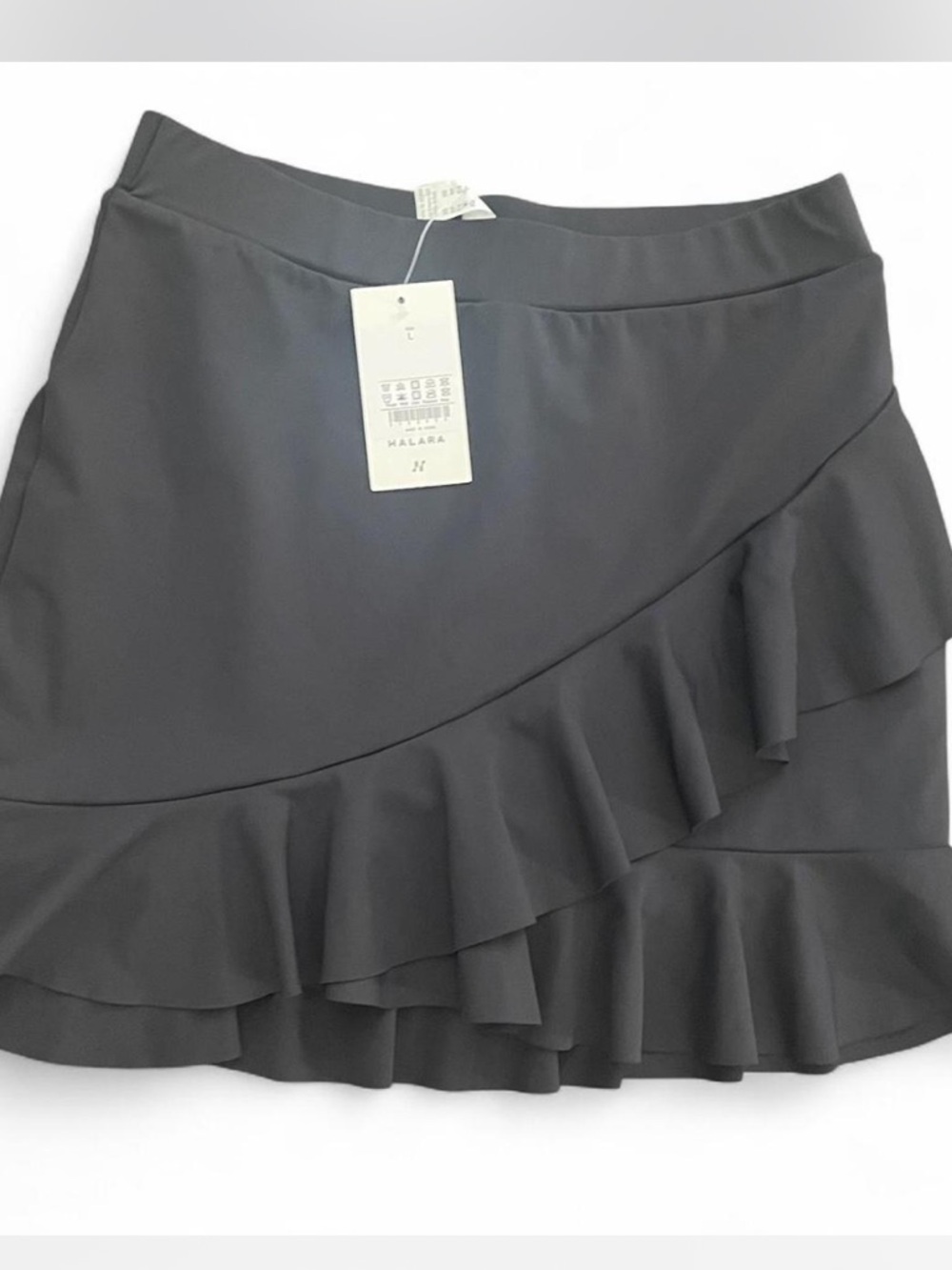 NWT women’s HALARA black tennis skirt with ruffle. 
Size L